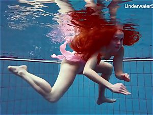 redhead Simonna showcasing her assets underwater
